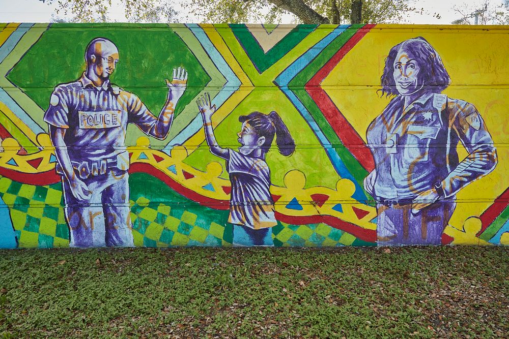                         Murals on a long wall next to the North District police station in the Liberty City neighborhood of…