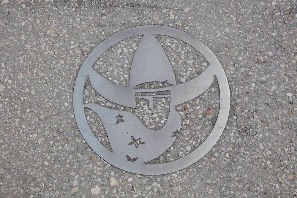                         Sidewalk art acknowledging the city's historic cowboy heritage in downtown Kissimmee, Florida, an…
