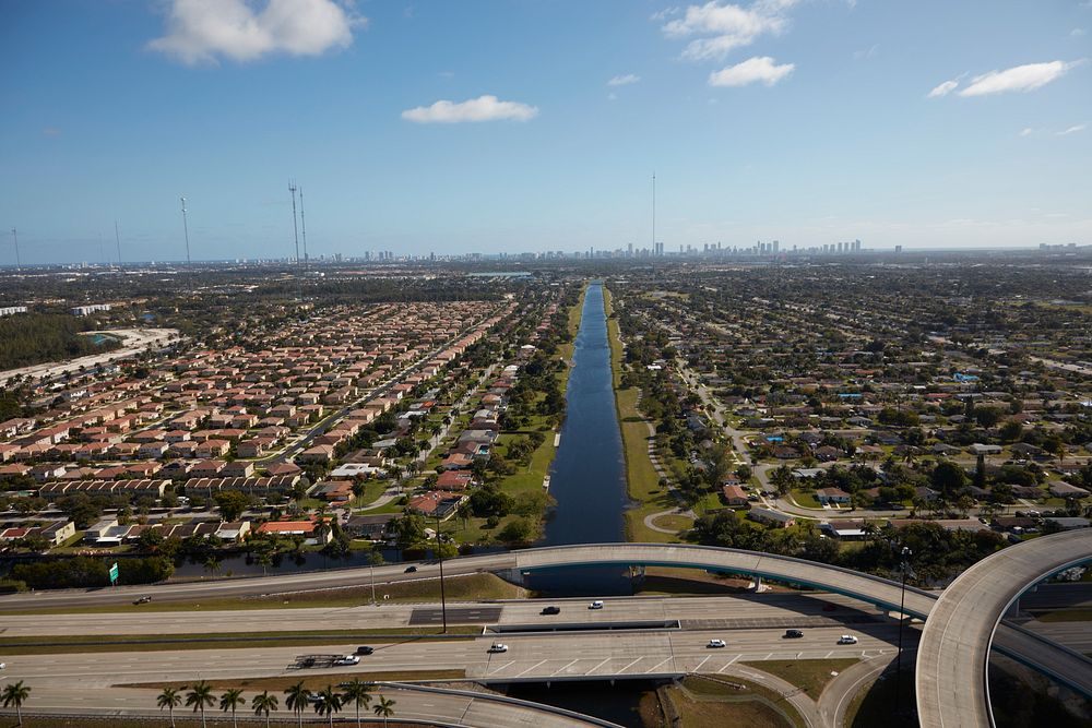                         Aerial view of a canal and large housing development in Miami Gardens, a city just above Miami…