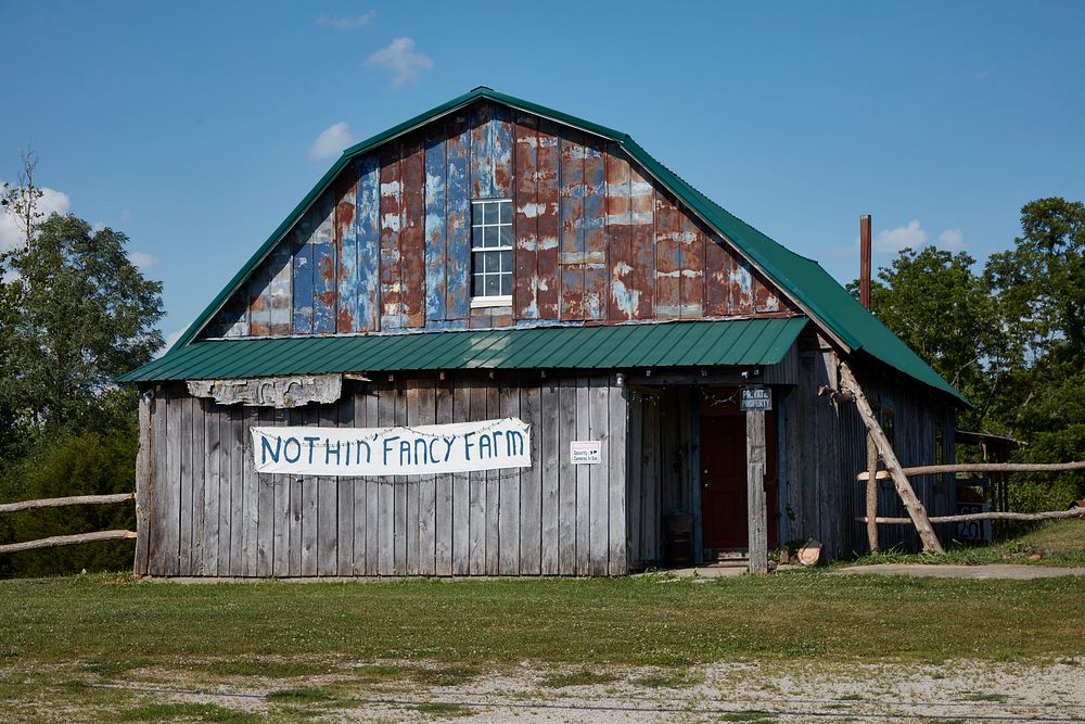                         The "Nothin' Fancy Farm" sign, placed on a most ordinary barn, presumably by an owner who knows his…