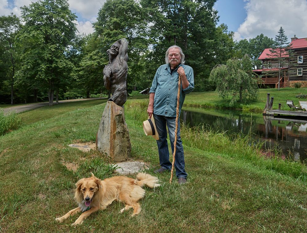                         Celebrated sculptor Sam McKinney (and friend) relax near one of Mr. McKinney's creations in the…