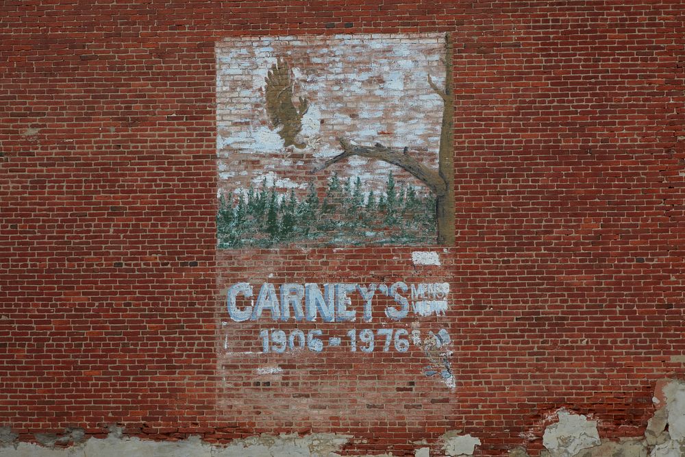                         Carney's Men's Wear store in Rochelle, Illinois, lasted 70 years. This now-faded "ghost" ad for the…
