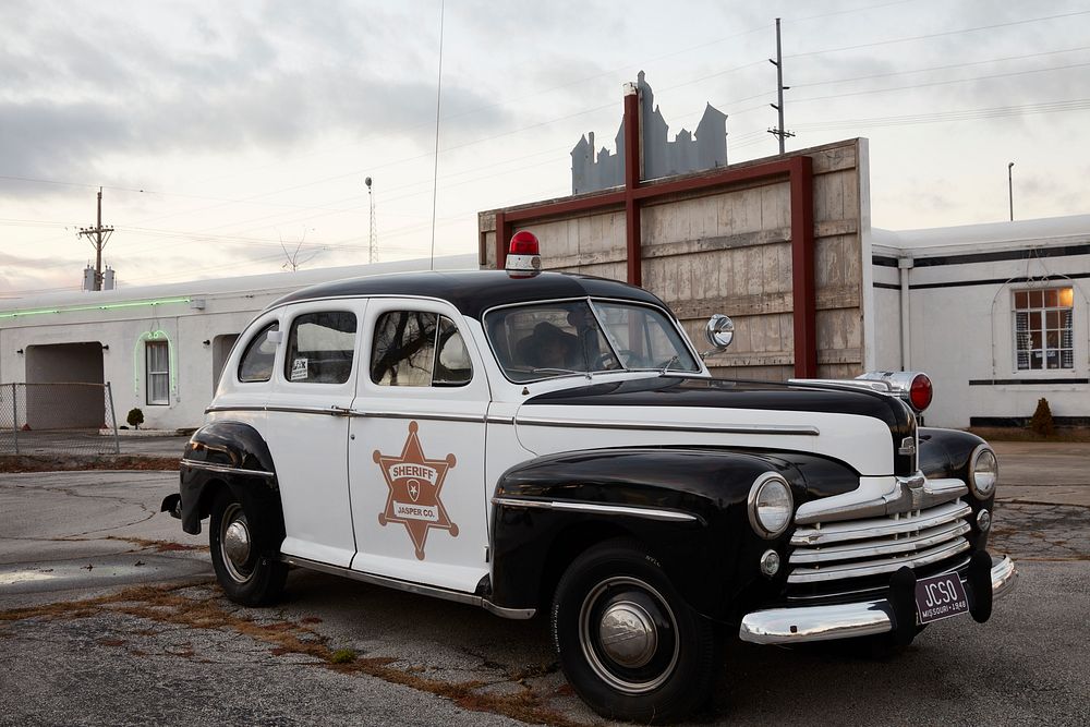                         An old police car next to the Court Motel accents the vintage ambience along the historic U.S. Route…