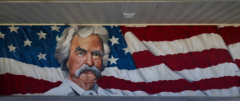                         A surprisingly elegant mural depicting Mark Twain on the facade of a gas station in Hannibal, a city…