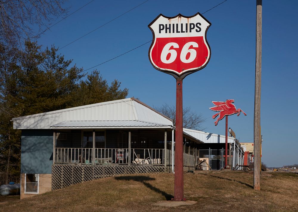                         The classic Mobil Gas Pegasus, or flying horse, sign in the distance beyond a newer Phillips 66…