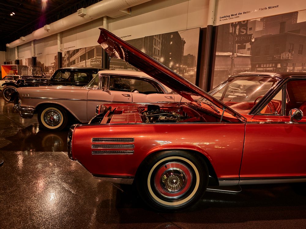                         A 1963 Chrysler, with the hood open, leads a parade of classic cars at the National Museum of…