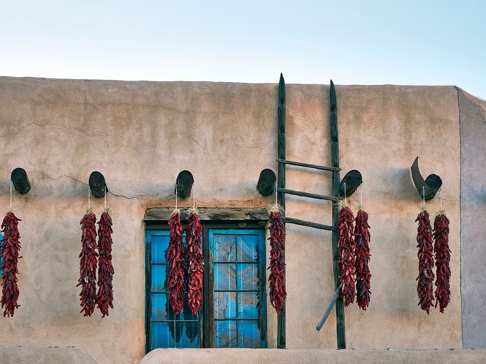                         Old-style adobe building adorned with hot-pepper chiles in Taos, New Mexico, once a sleepy southern…