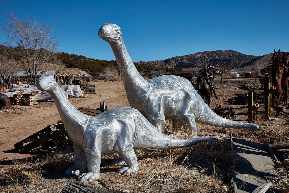                         Metal-art dinosaurs displayed outside the Casa Cristal Pottery home-and-garden roadside store near…