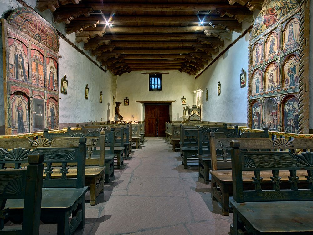                         The sanctuary, looking rearward from the altar, at the El Santuario de Chimayo, a humble but…