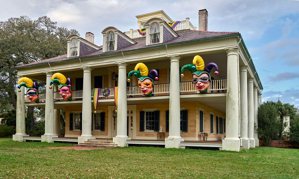                         Ten-foot-tall, 700-pound fiberglass jesters decorate the mansion during the annual Carnival season…