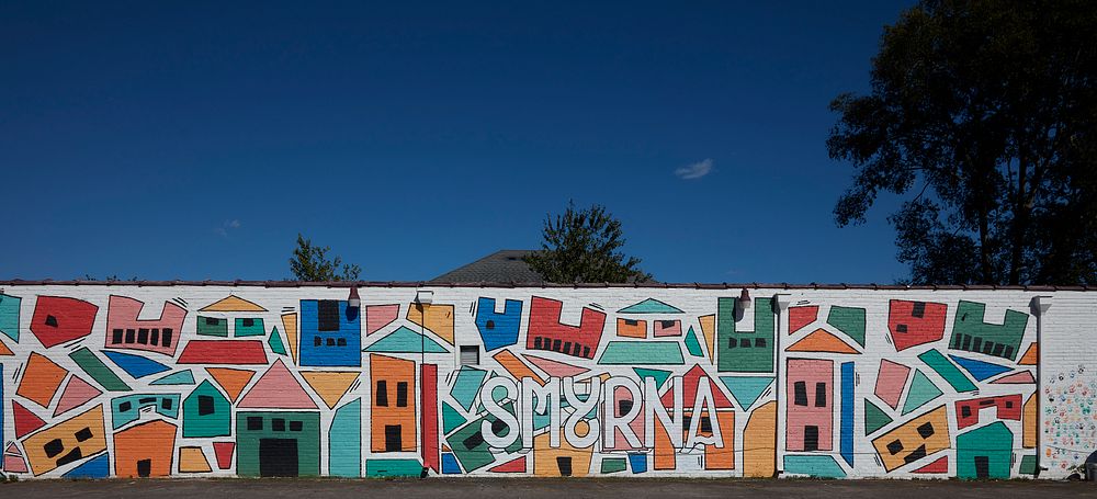                         Somewhat obscured in this town mural is the name of the town in Smyrna, an exurban town near…
