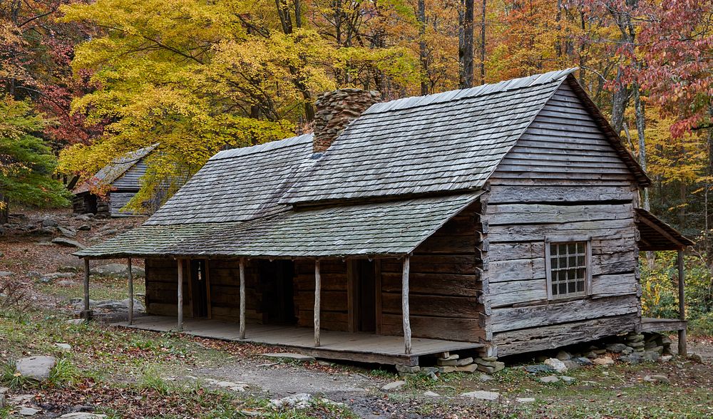                         Rustic homes, including the Noah "Bud" Ogle Cabin, a late-19th-century "dogtrot cabin," foreground…