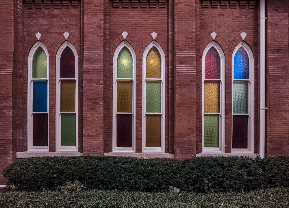                         Colorful windows of the legendary 2,362-seat Ryman Auditorium concert and events hall in Nashville…