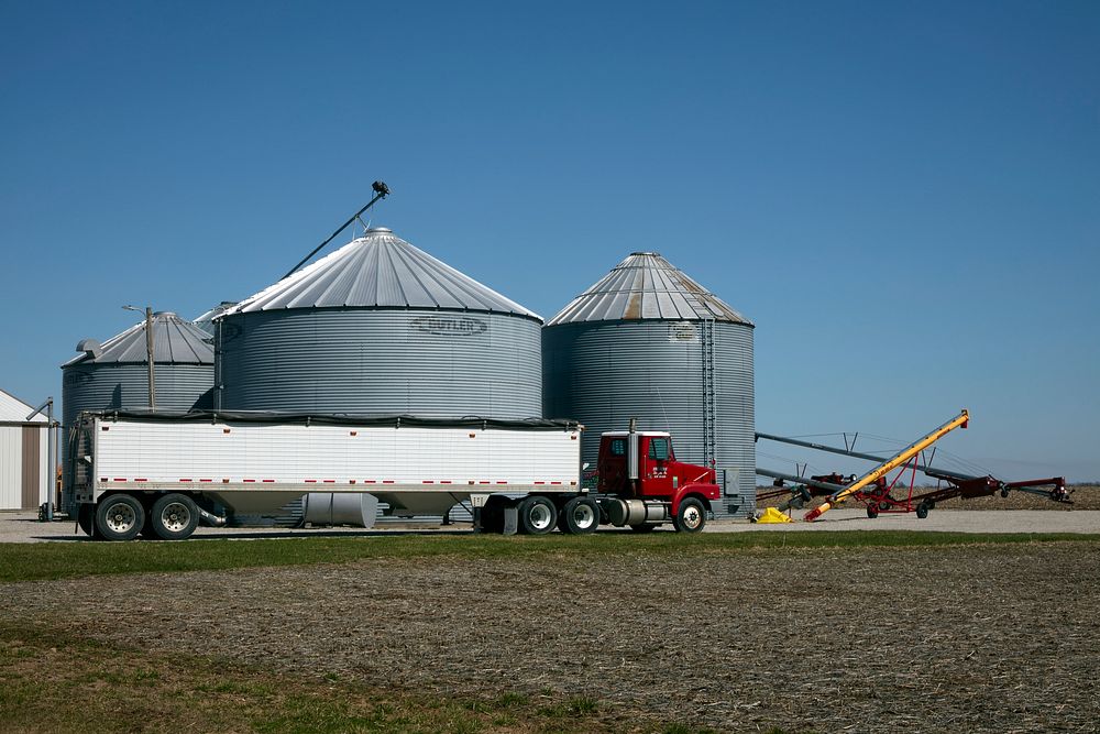                         A long feed truck parks alongside metal silos in Randolph County, Missouri                        