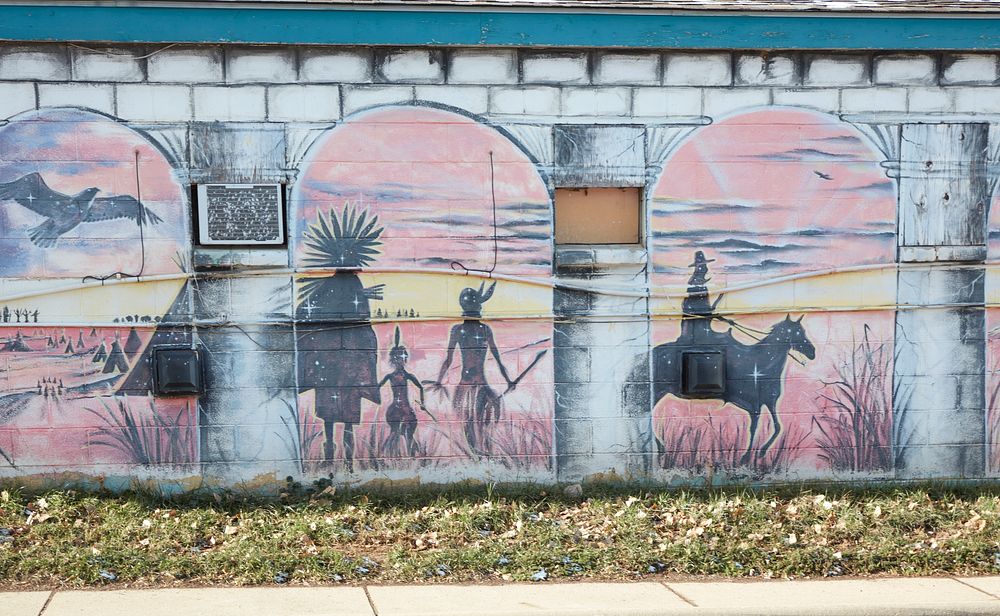                         Portion of a fading mural on an old building in Spearfish, a city of about 11,000 population (as of…