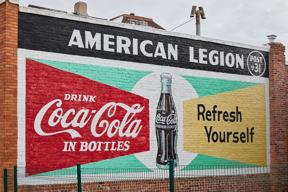                         A Coca-Cola sign on the side of the American Legion Hall in Lead, a onetime gold-mining boomtown in…
