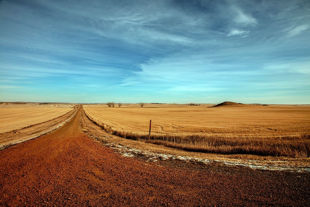                         A dirt road (seemingly to nowhere) and surrounding late-fall fields near Lefor, North Dakota        …