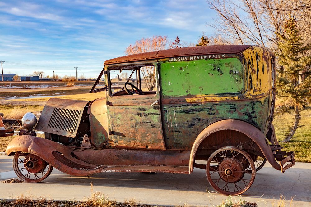                         A very old and rusted automobile with a message beside the road outside Devils Lake, North Dakota   …
