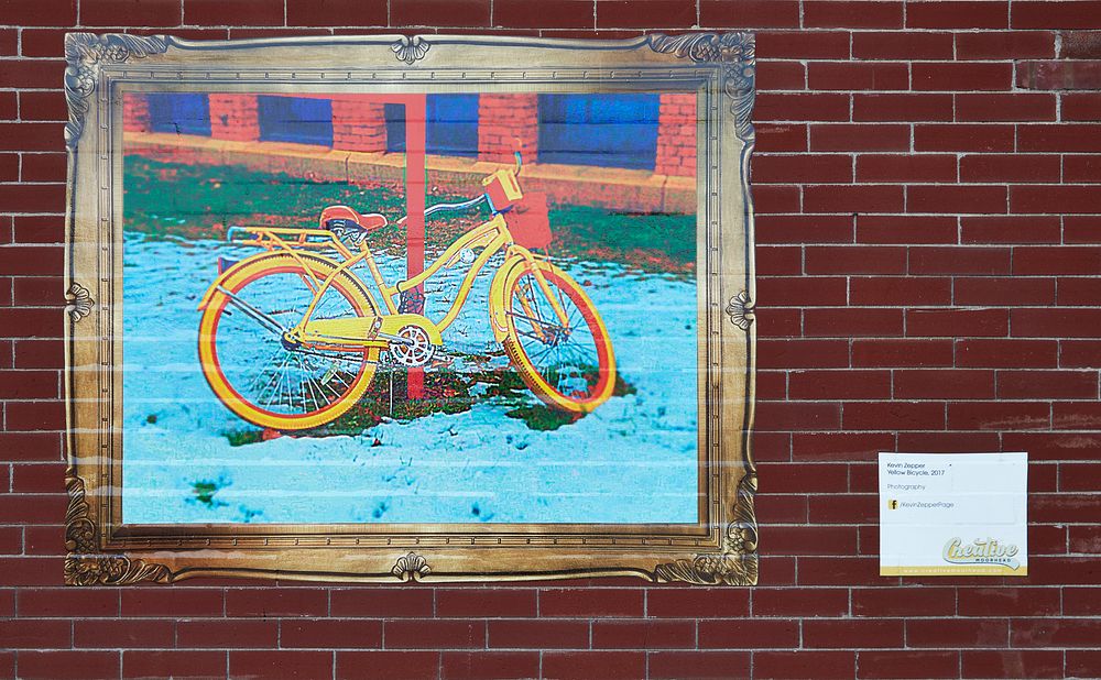                         Kevin Zepper's 2017 artwork, entitled "Yellow Bicycle," on a brick wall of the Kassenburg Building…