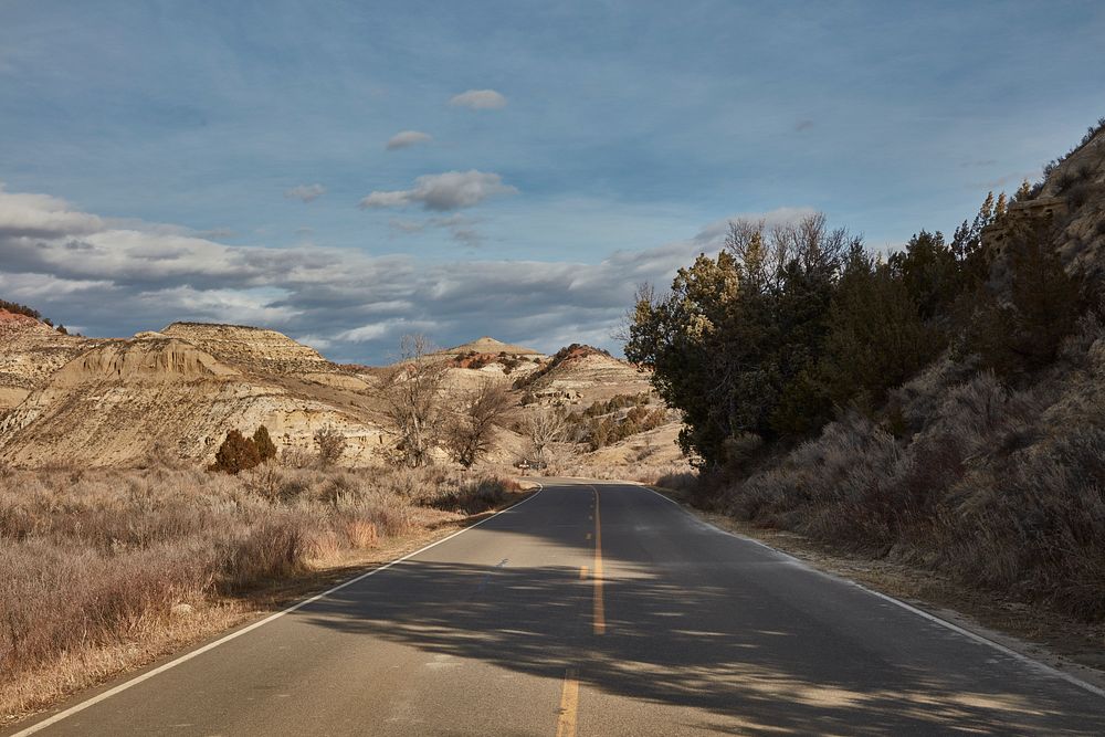                         View down the winding road through Theodore Roosevelt National Park near Medora in southwest North…