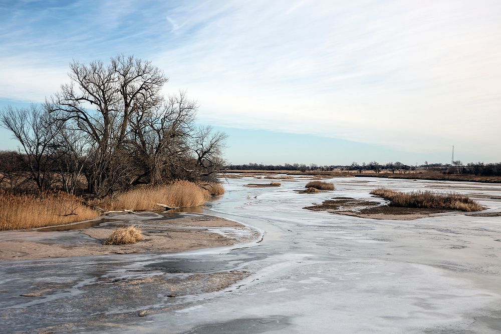                         Small islands in the Platte River as it passes below a small, legendary, bridge informally called…