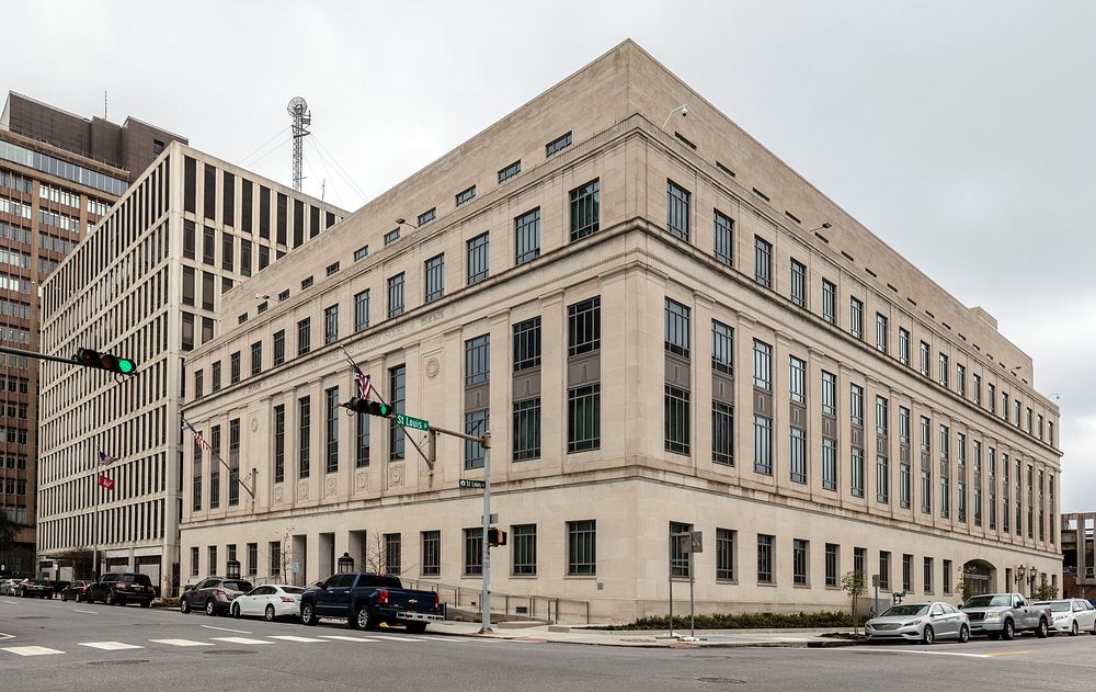                         The John A. Campbell U.S. Courthouse in Mobile, Alabama is a white, limestone building resting on a…