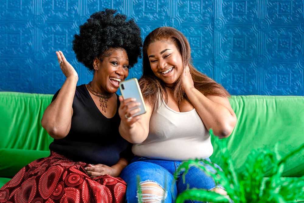 Happy plus-size women taking selfie