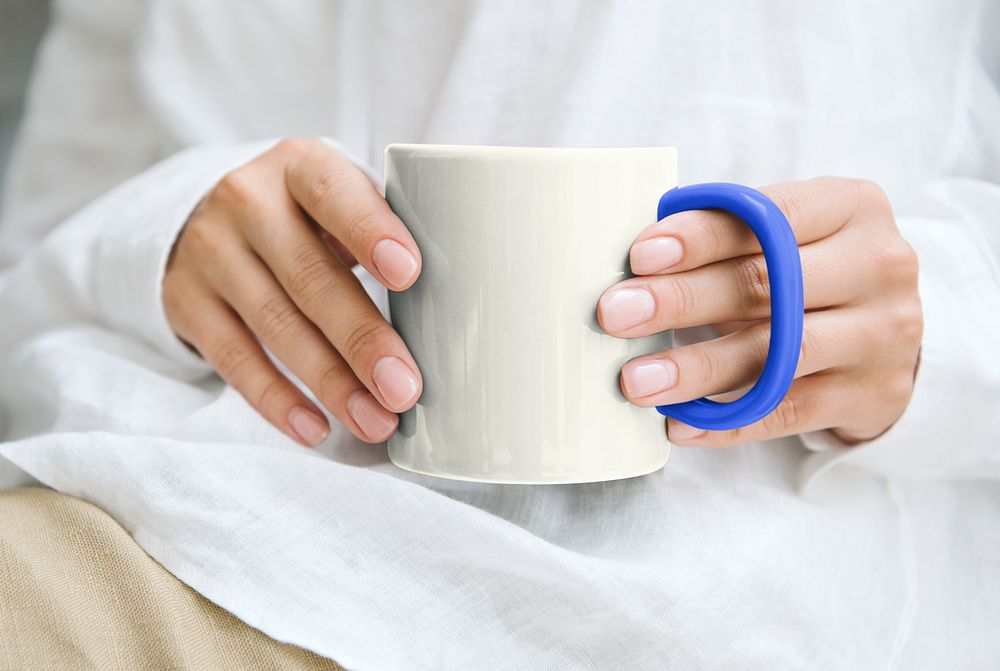 Woman holding coffee mug with design space