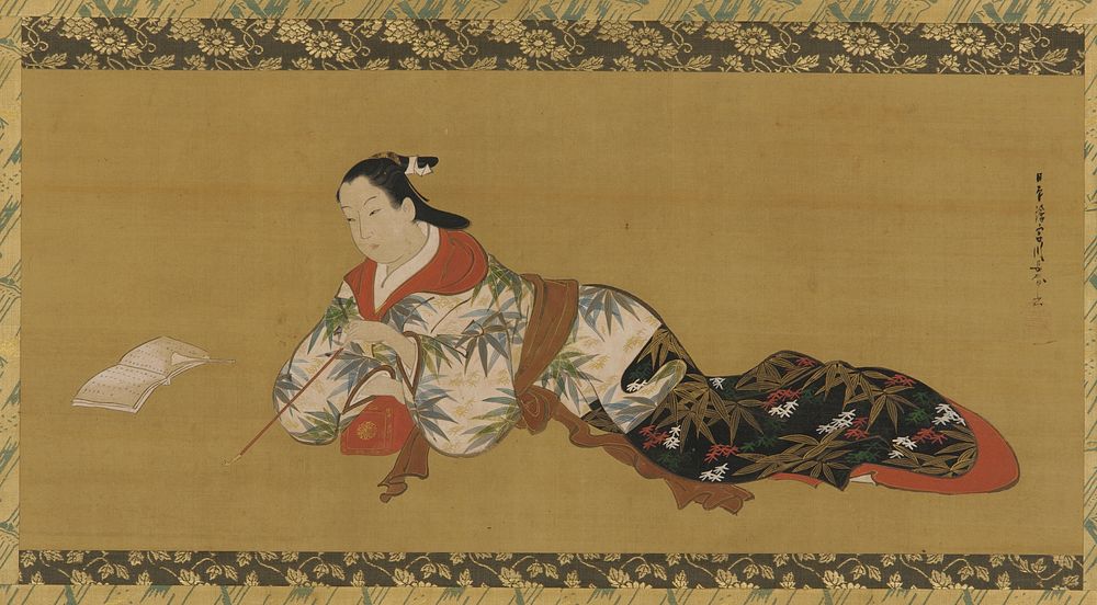 Yujo reclining and reading a musical score