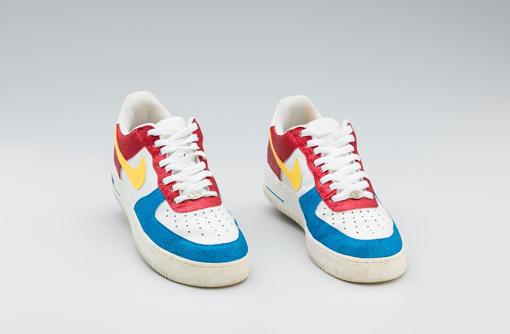 Red, white, yellow, and blue Nike sneakers worn by Big Boi of Outkast