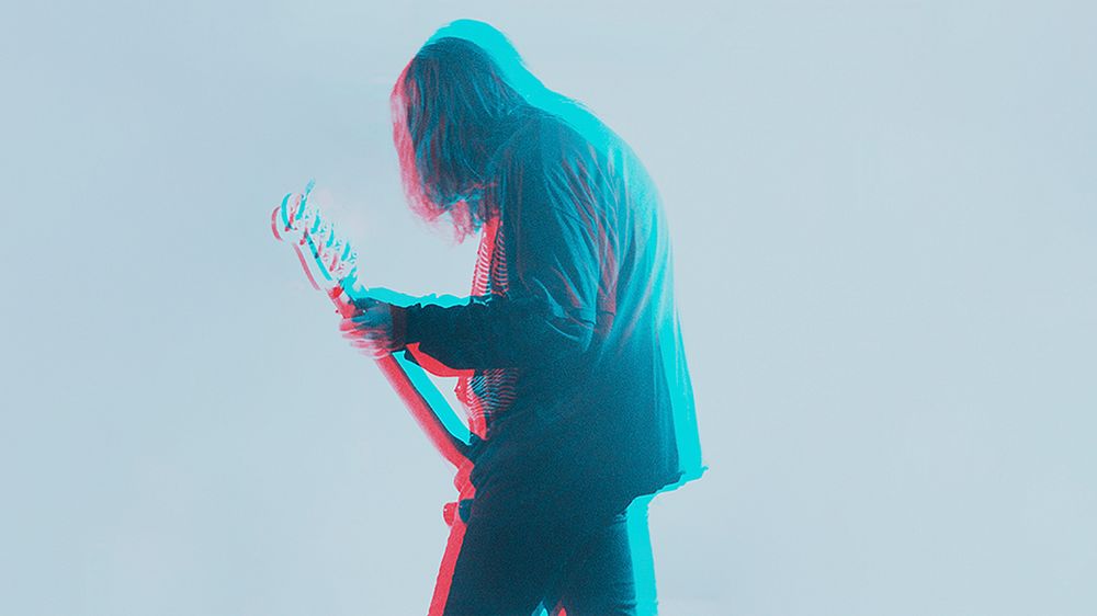 Bassist performing background, double color exposure