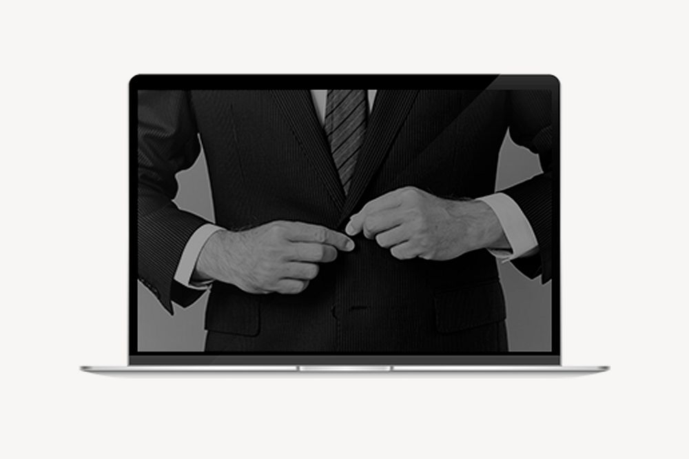 Businessman buttoning suit, laptop screen psd