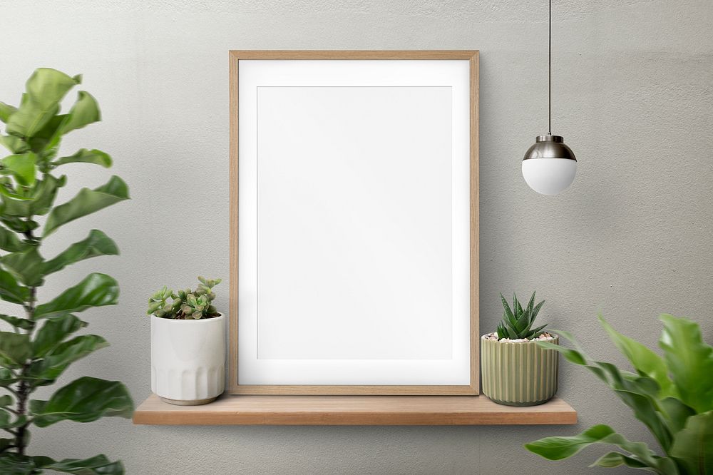 Wooden picture frame psd mockup on a shelf with plants