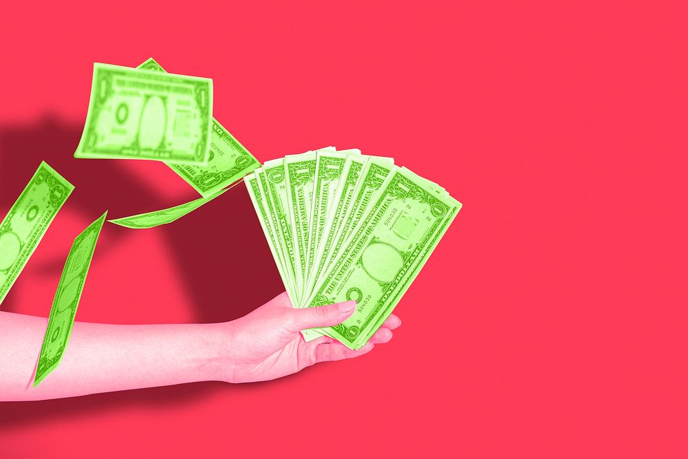 Hand holding money, red background