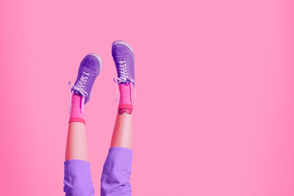 Pink background, woman's legs up in the air