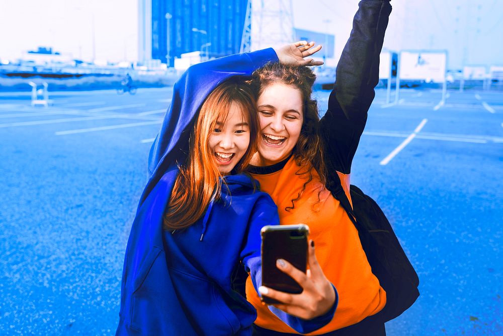 Girls taking selfie, diverse friendship