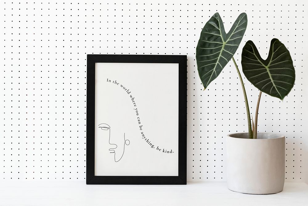 Picture frame mockup psd next to houseplants home decor