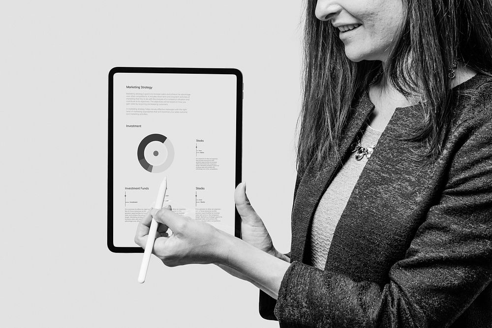 Businesswomen pointing tablet screen, business analytics photo