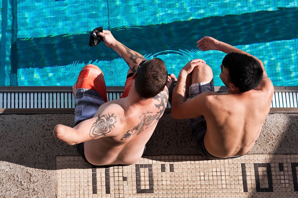 U.S. Air Force Tech. Sgt. Leonard Anderson and Staff Sgt. Daniel Crane review swimming techniques together during the…