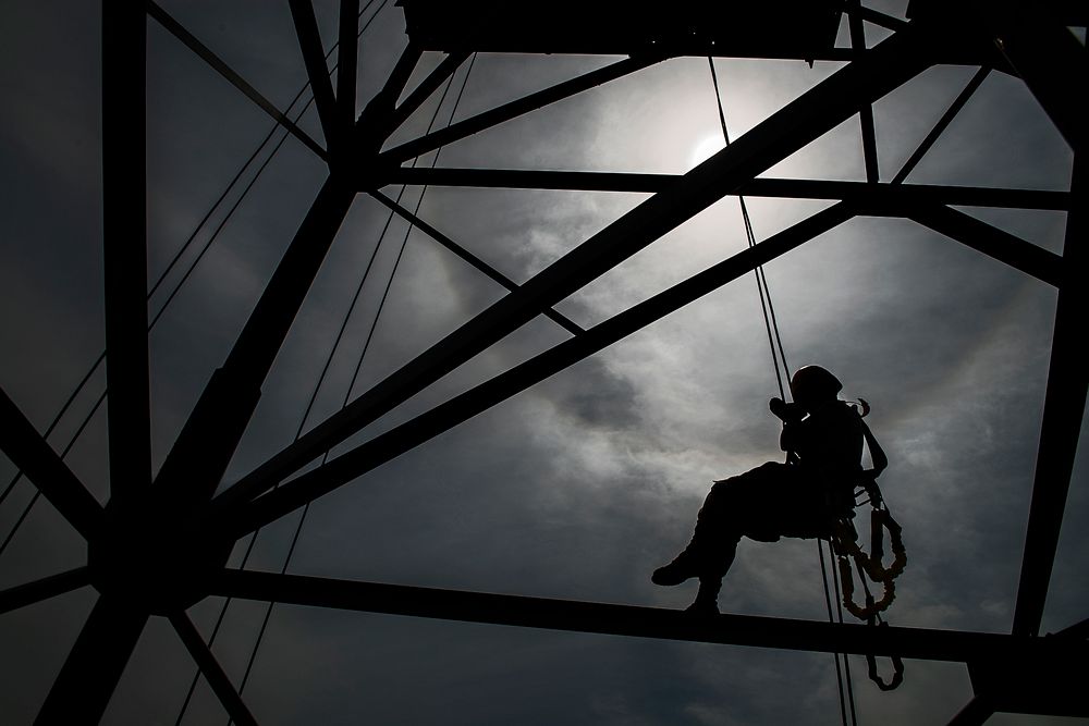 U.S. Air Force Senior Airman Emma Duff, a broadcaster with American Forces Network, rappels through beams during tower…
