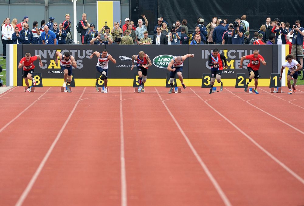 Competitors leave the starting blocks during a 100-meter sprint heat during the Invictus Games 2014 in London Sept. 11, 2014.