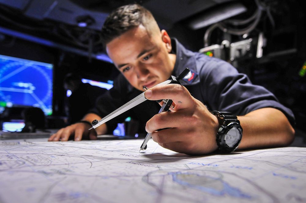 150901-N-WK391-035 PACIFIC OCEAN (Sept. 01, 2015) Operations Specialist 2nd Class Taiese Gaono tracks a course on the chart…