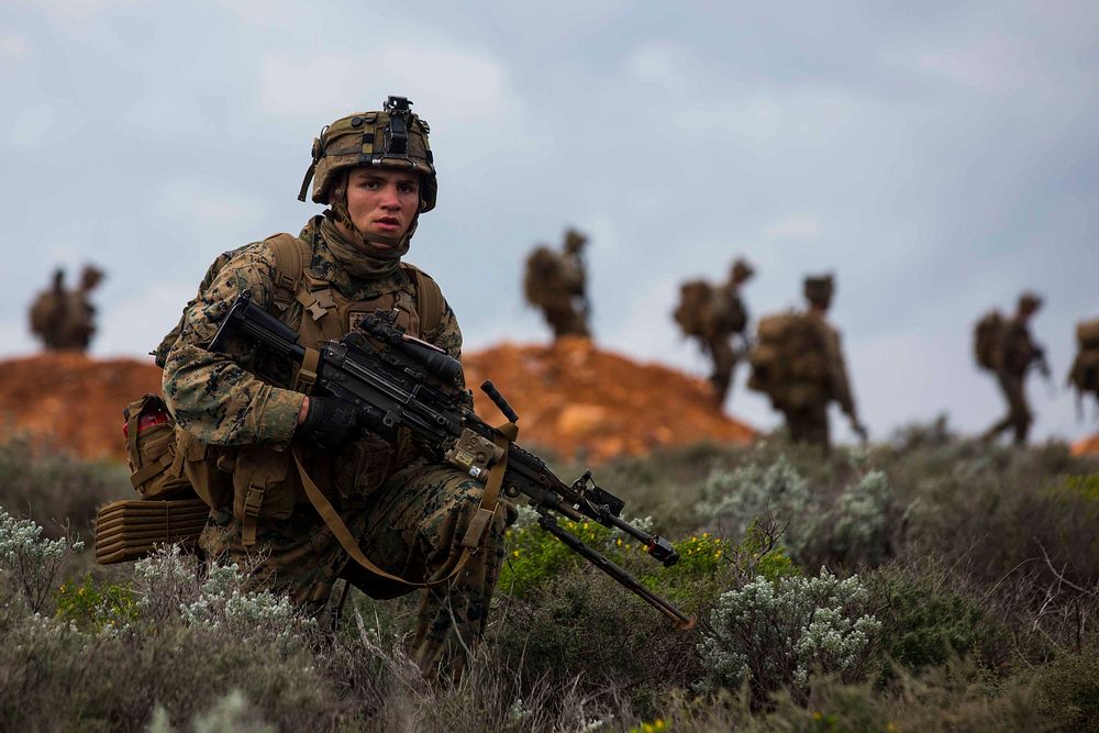 U.S. Marine Corps Lance Cpl. Eric J. Radtke, a rifleman, scans the area outside of an objective during Exercise Hamel at…