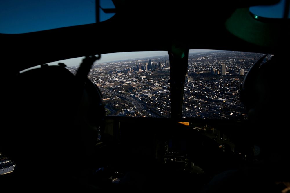 Officers with the U.S. Customs and Border Protection Air and Marine Operations fly an AS350 A-Star helicopter over downtown…