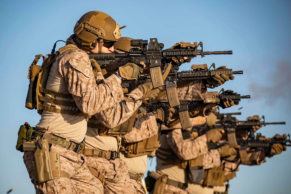 U.S. Marines assigned to the 22nd Marine Expeditionary Unit fire M4A1 carbines during an exercise on the flight deck aboard…