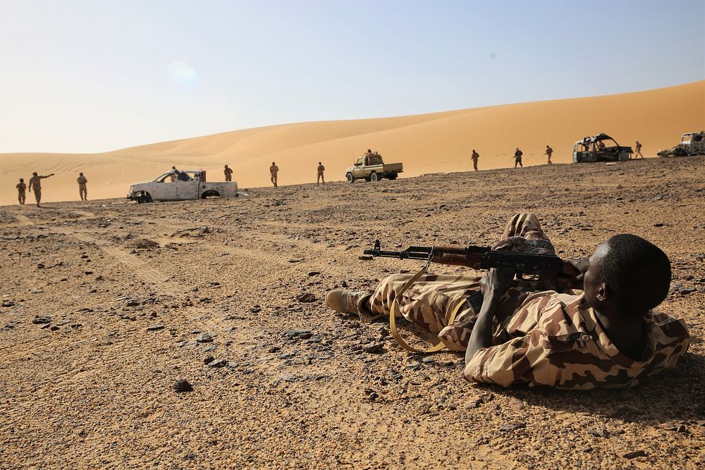 A Chadian Army Soldier who is a simulated casualty awaits medical assistance during a simulated assault in Faya-Largeau…