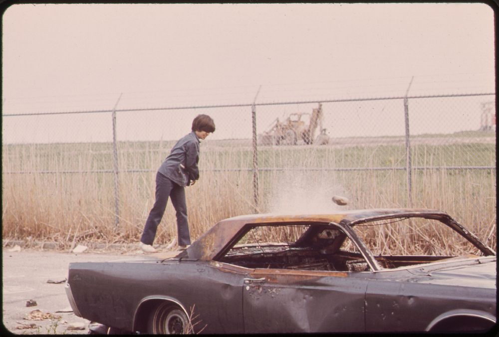 Logan Airport Area. Neighborhood Boys Play Rough with an Abandoned Car behind the Wood Island Station of the MBTA. Original…