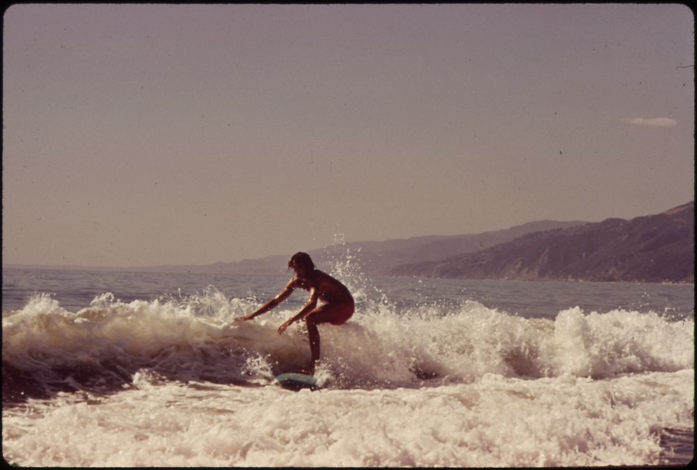 Surfing Along Malibu Beach, California. 10/1972. Original public domain image from Flickr