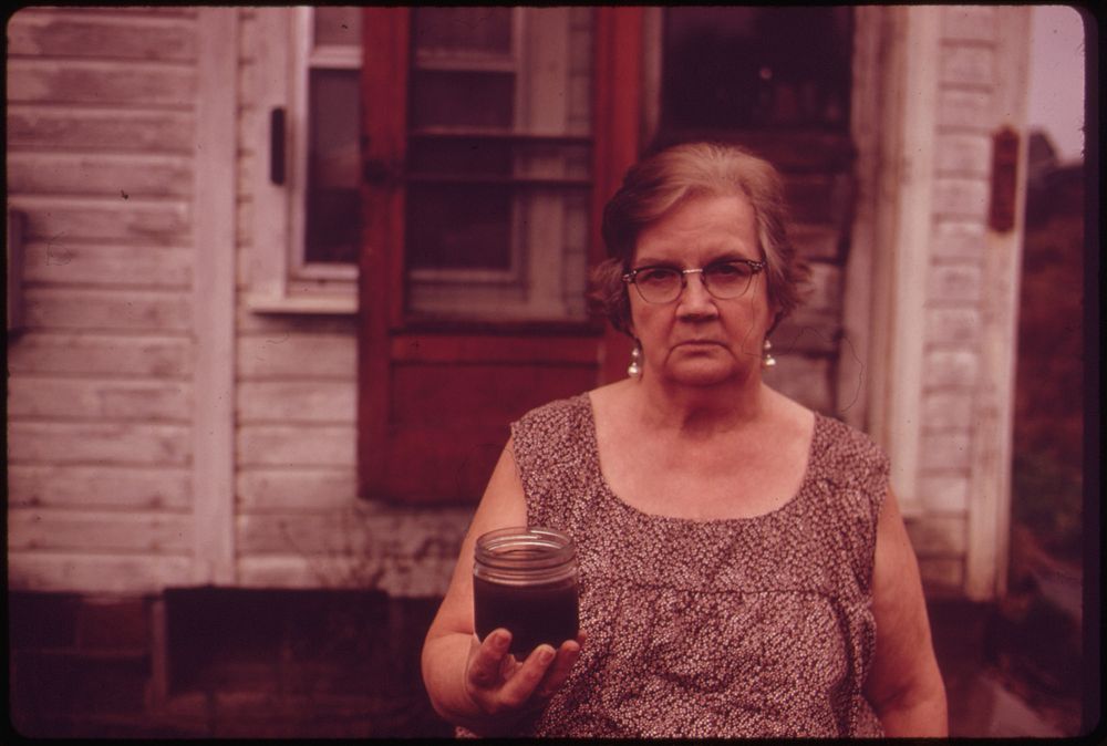 Mary Workman Holds A Jar of Undrinkable Water That Comes from Her Well, and Has Filed A Damage Suit Against the Hanna Coal…