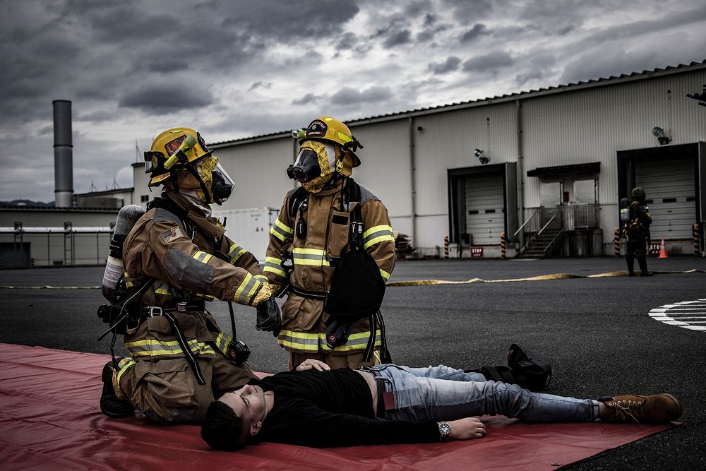 Firefighters at Marine Corps Air Station (MCAS) Iwakuni respond to a simulated casualty during a chemical exposure drill as…